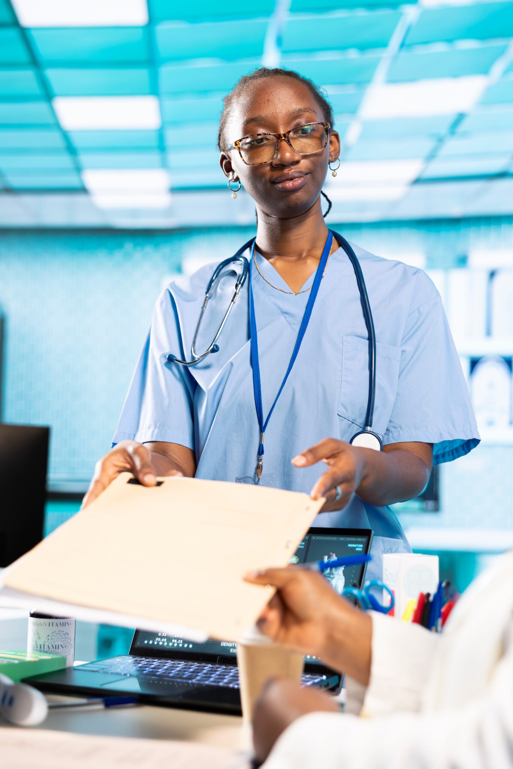 African American Female Nurse Provides Medic With Patient File Scaled